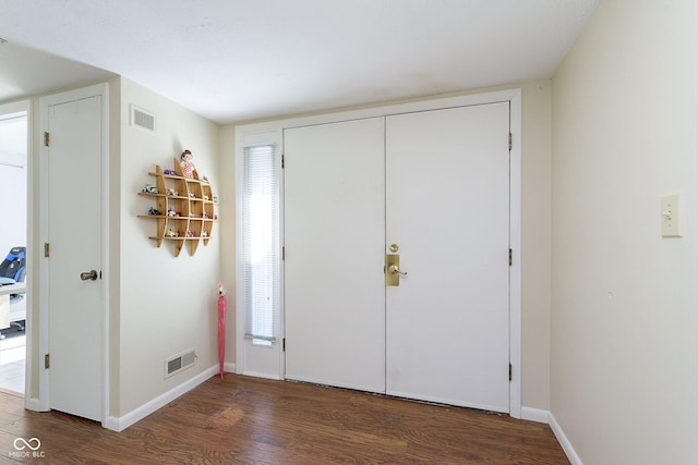 foyer with dark hardwood / wood-style floors