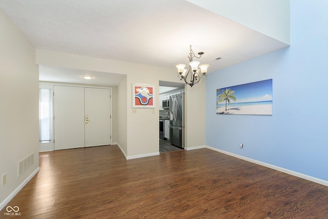 interior space with dark hardwood / wood-style floors and a chandelier