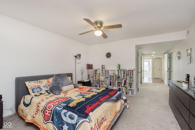 bedroom featuring light colored carpet and ceiling fan