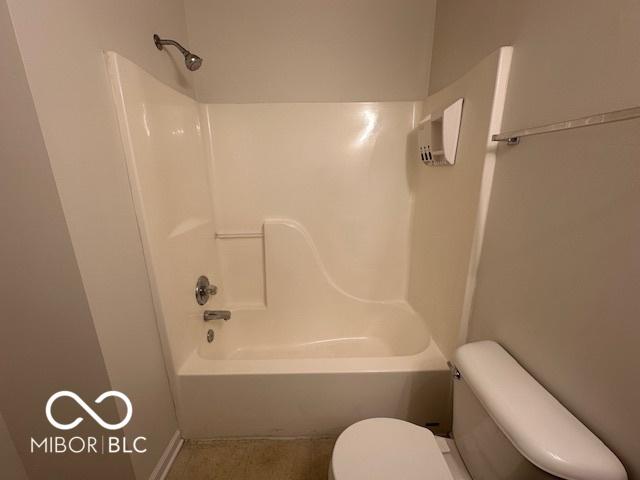 bathroom with shower / bath combination and toilet