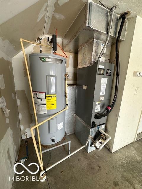 utility room with heating unit and water heater