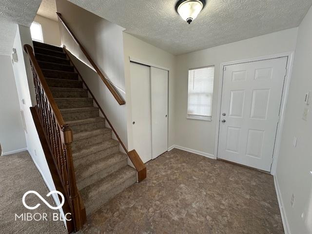 entryway with a textured ceiling