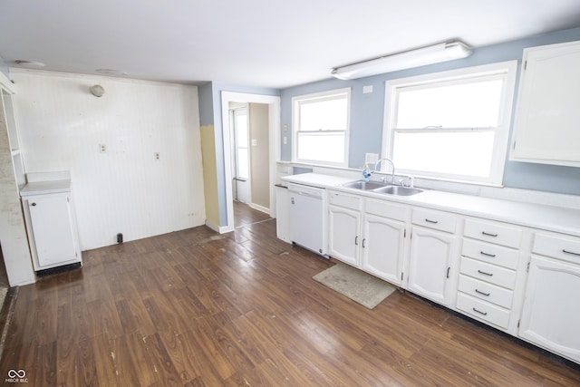 kitchen with sink, dishwasher, white cabinetry, and dark hardwood / wood-style floors