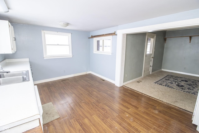 basement with sink and dark hardwood / wood-style floors