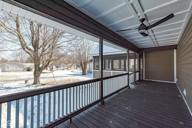 snow covered deck featuring ceiling fan and a sunroom