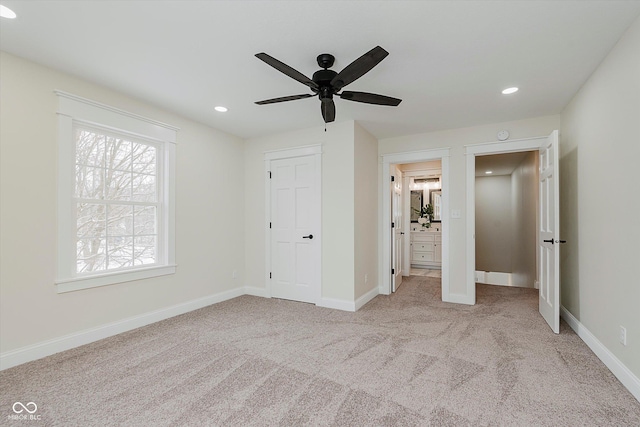 unfurnished bedroom with light carpet and ceiling fan