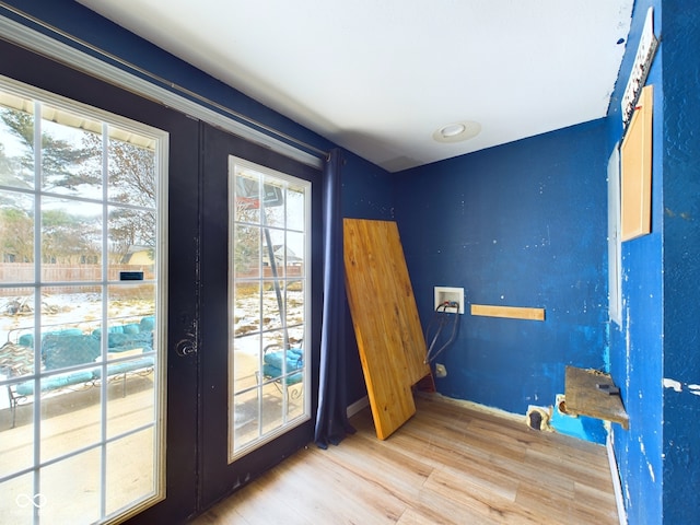 doorway with hardwood / wood-style floors and french doors