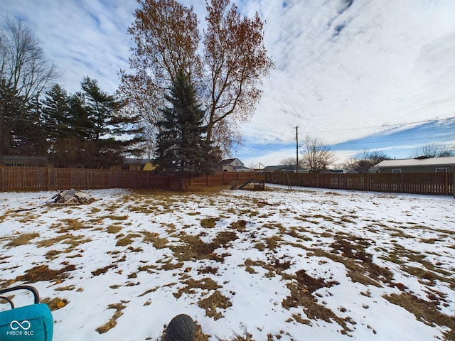 view of yard layered in snow