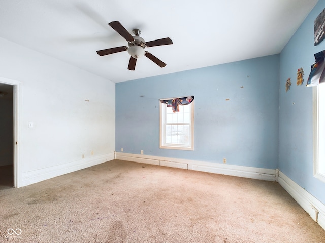 carpeted empty room featuring ceiling fan