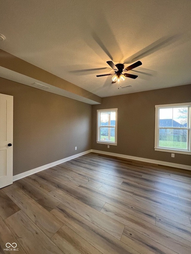 spare room with hardwood / wood-style flooring and ceiling fan