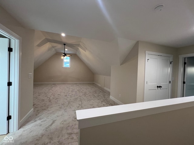 additional living space featuring light carpet, lofted ceiling, and ceiling fan