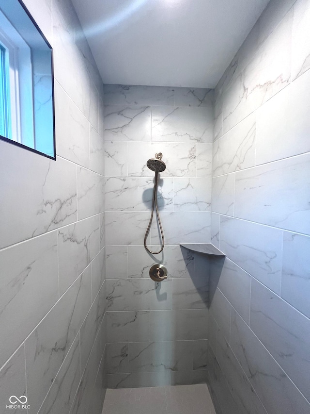 bathroom with tiled shower