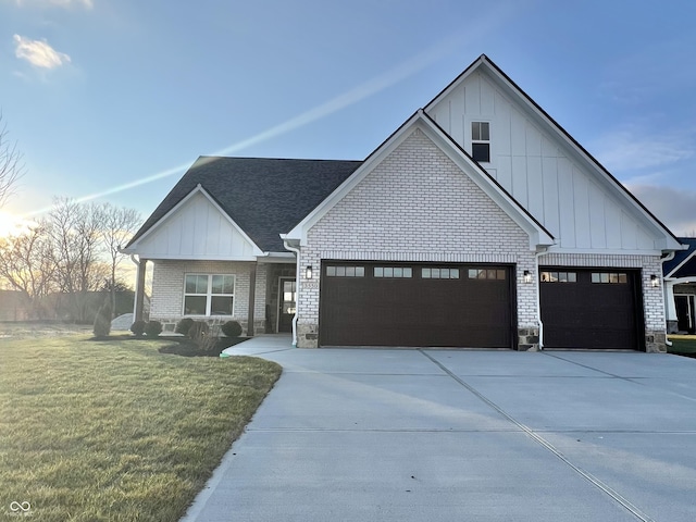 modern inspired farmhouse featuring a garage and a yard