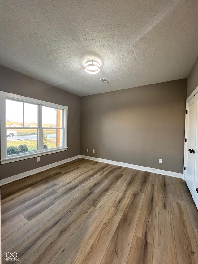 interior space with light hardwood / wood-style floors and a textured ceiling