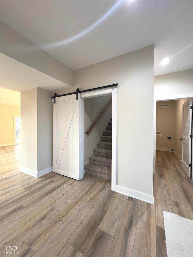 interior space featuring light hardwood / wood-style flooring and a barn door