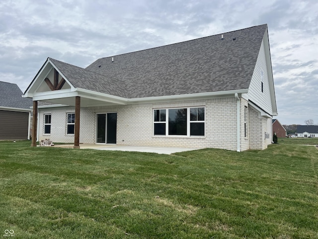 rear view of house with a patio area and a lawn