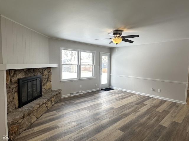 unfurnished living room with hardwood / wood-style flooring, ceiling fan, and a fireplace