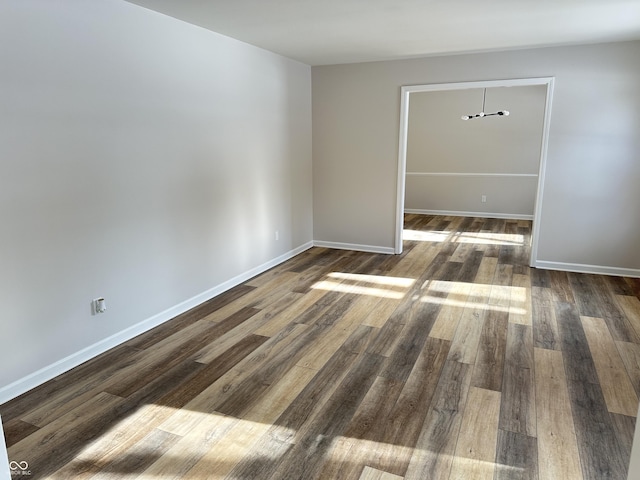 spare room featuring dark wood-type flooring