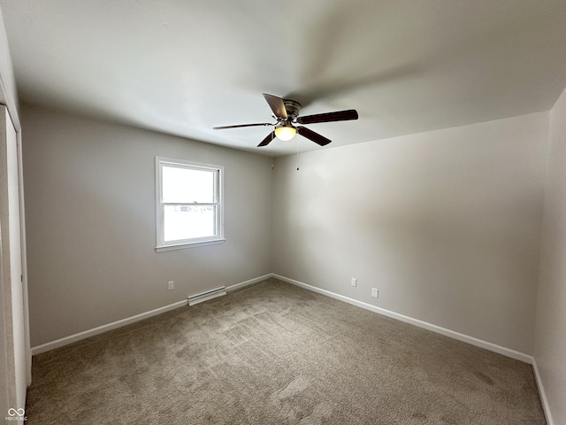 carpeted spare room with ceiling fan