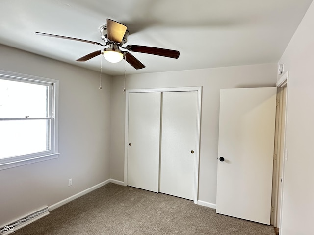 unfurnished bedroom with light carpet, ceiling fan, and a closet