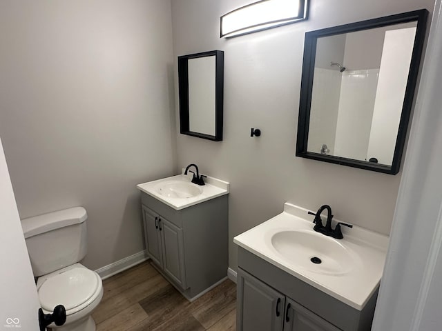 bathroom with vanity, wood-type flooring, and toilet