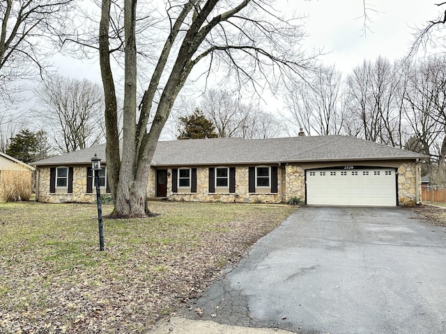 single story home with a garage and a front lawn