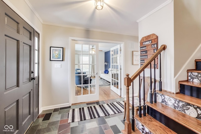 foyer featuring crown molding and french doors