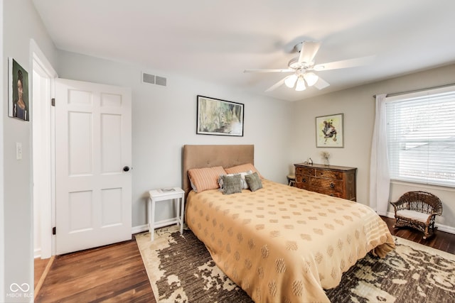 bedroom with dark hardwood / wood-style flooring and ceiling fan