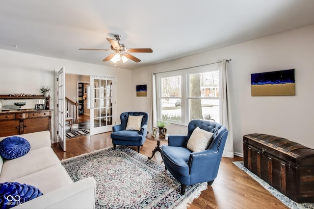 living room featuring french doors, ceiling fan, and wood-type flooring