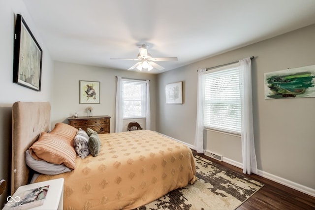 bedroom with ceiling fan and dark hardwood / wood-style floors