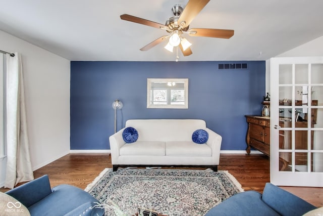 living room featuring hardwood / wood-style floors and ceiling fan