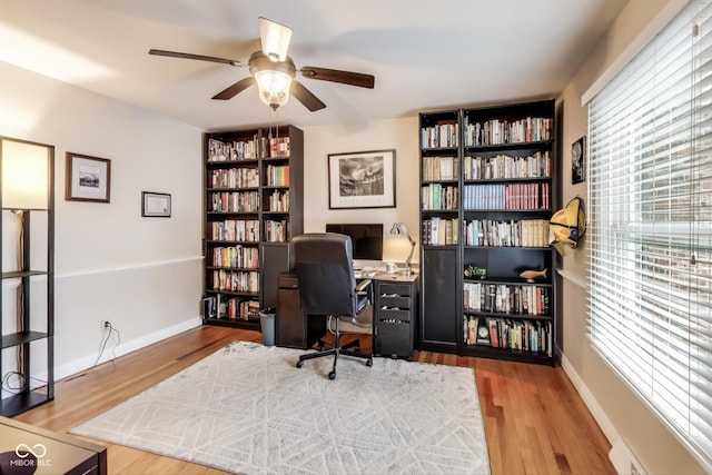 office with hardwood / wood-style flooring and ceiling fan