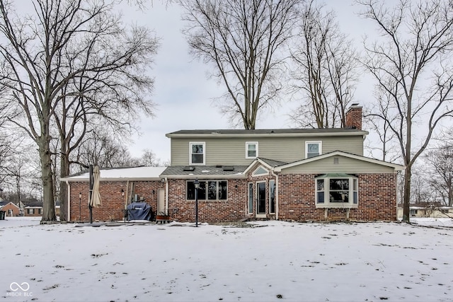 view of snow covered rear of property