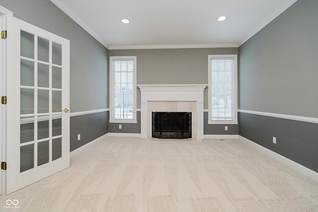 unfurnished living room with crown molding and light carpet