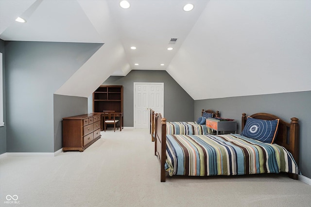 bedroom with lofted ceiling and light carpet