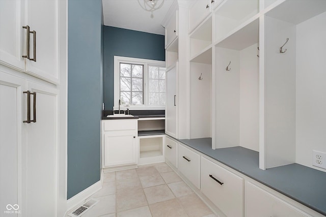 mudroom featuring sink and light tile patterned floors