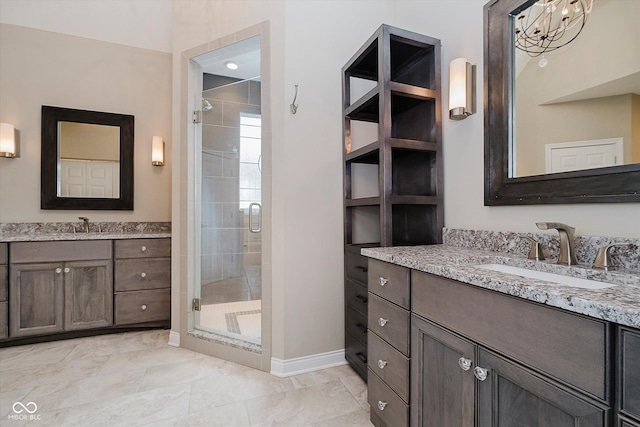 bathroom with vanity and a shower with shower door