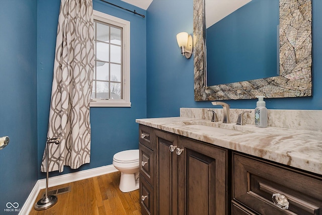 bathroom with vanity, hardwood / wood-style flooring, and toilet