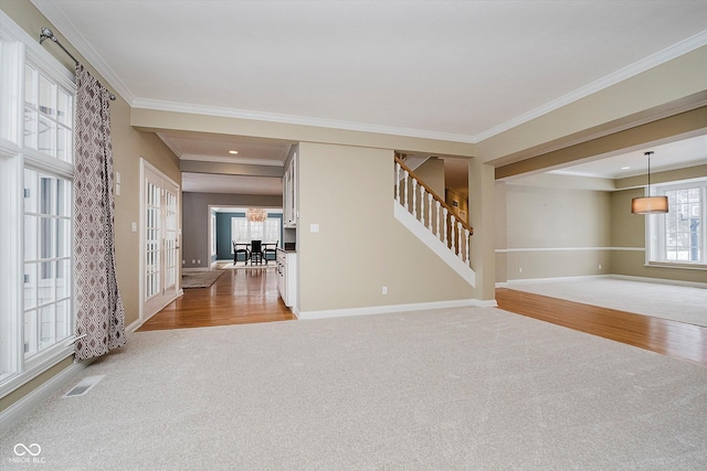 empty room with ornamental molding and carpet