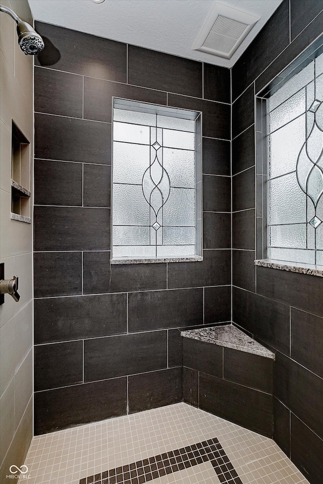 bathroom featuring a tile shower