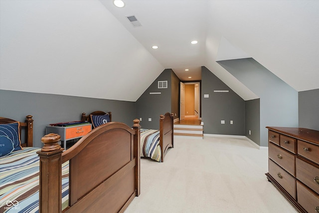 bedroom with lofted ceiling and light carpet