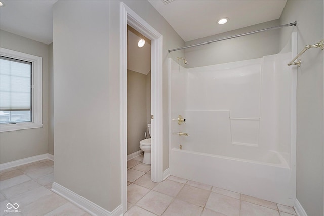 bathroom featuring tile patterned floors, bathing tub / shower combination, and toilet