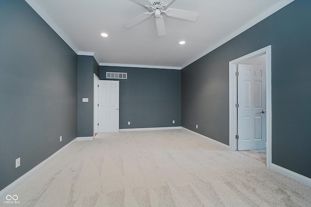 spare room featuring light carpet, ornamental molding, and ceiling fan