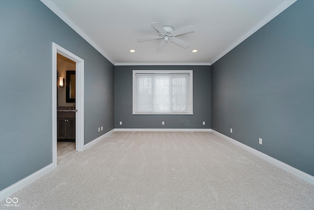 carpeted spare room featuring crown molding and ceiling fan