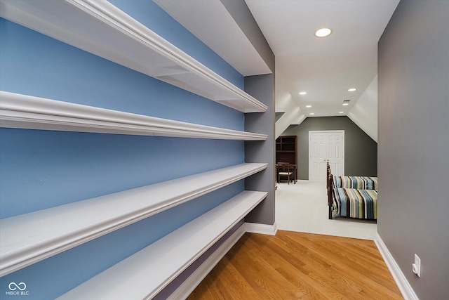 spacious closet featuring vaulted ceiling and wood-type flooring