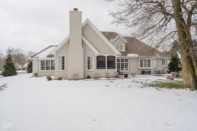 view of snow covered back of property