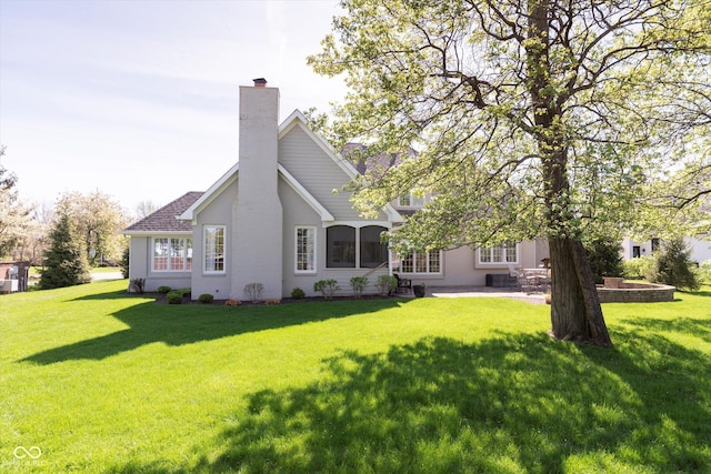 10295 Summerlin Way, Fishers, IN 46037 - rear view of house with a lawn, stucco siding, a patio area, and a chimney
