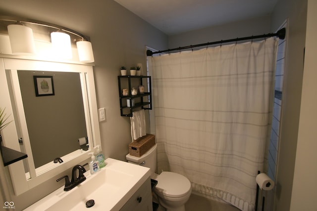 bathroom featuring curtained shower, vanity, and toilet