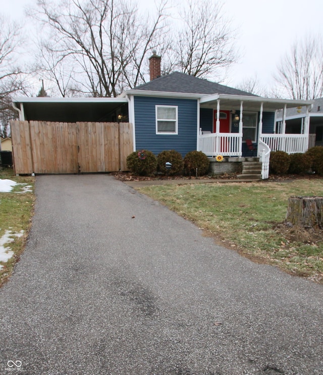 view of front of property with a porch and a carport