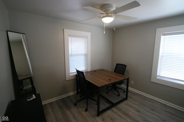 office area featuring a healthy amount of sunlight, dark hardwood / wood-style flooring, and ceiling fan